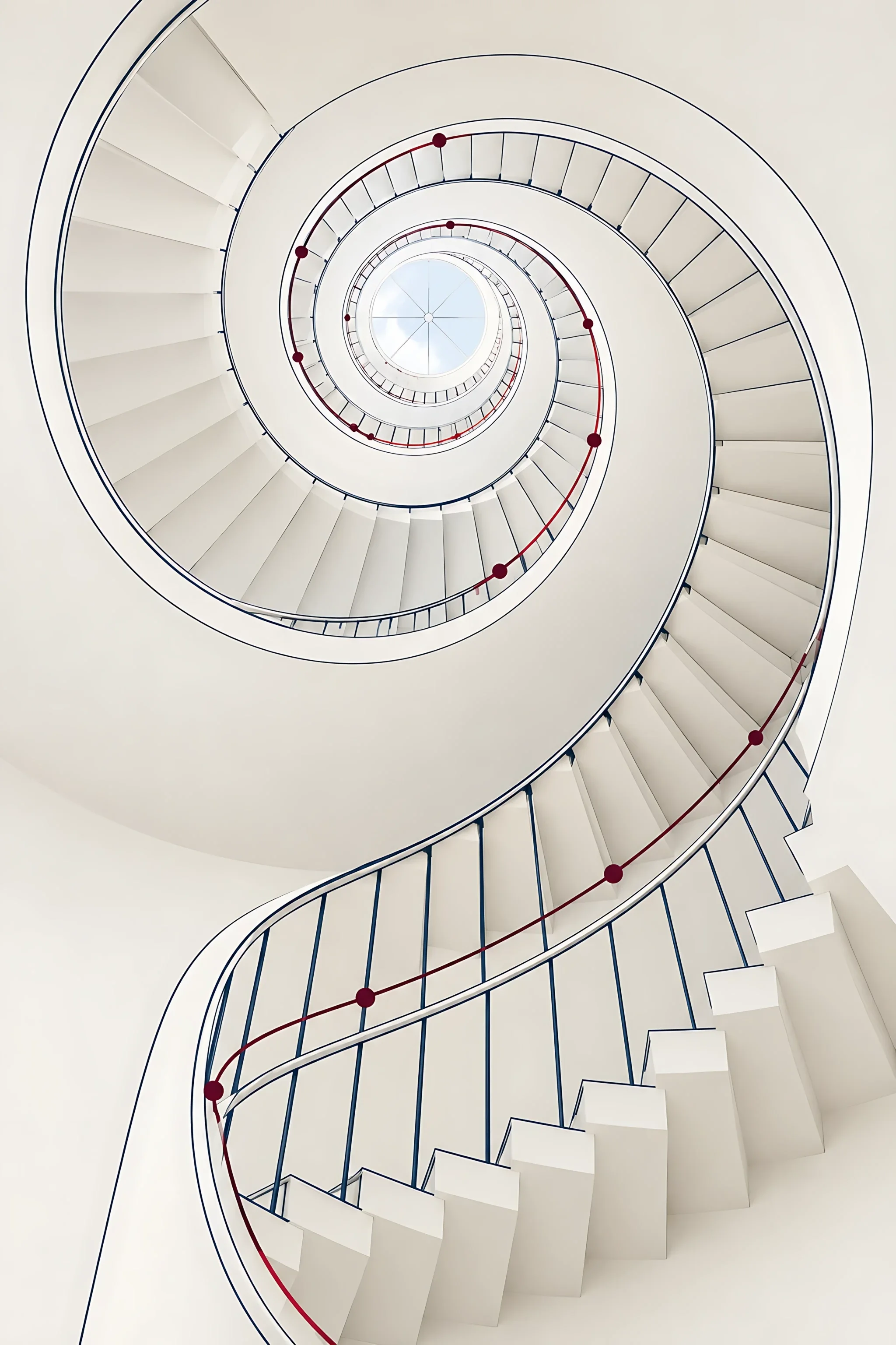 A white spiral staircase seen from below rising towards a skylight, with a maroon line climbing through it